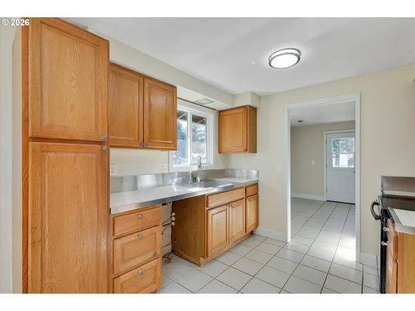 a kitchen with a sink appliances and cabinets