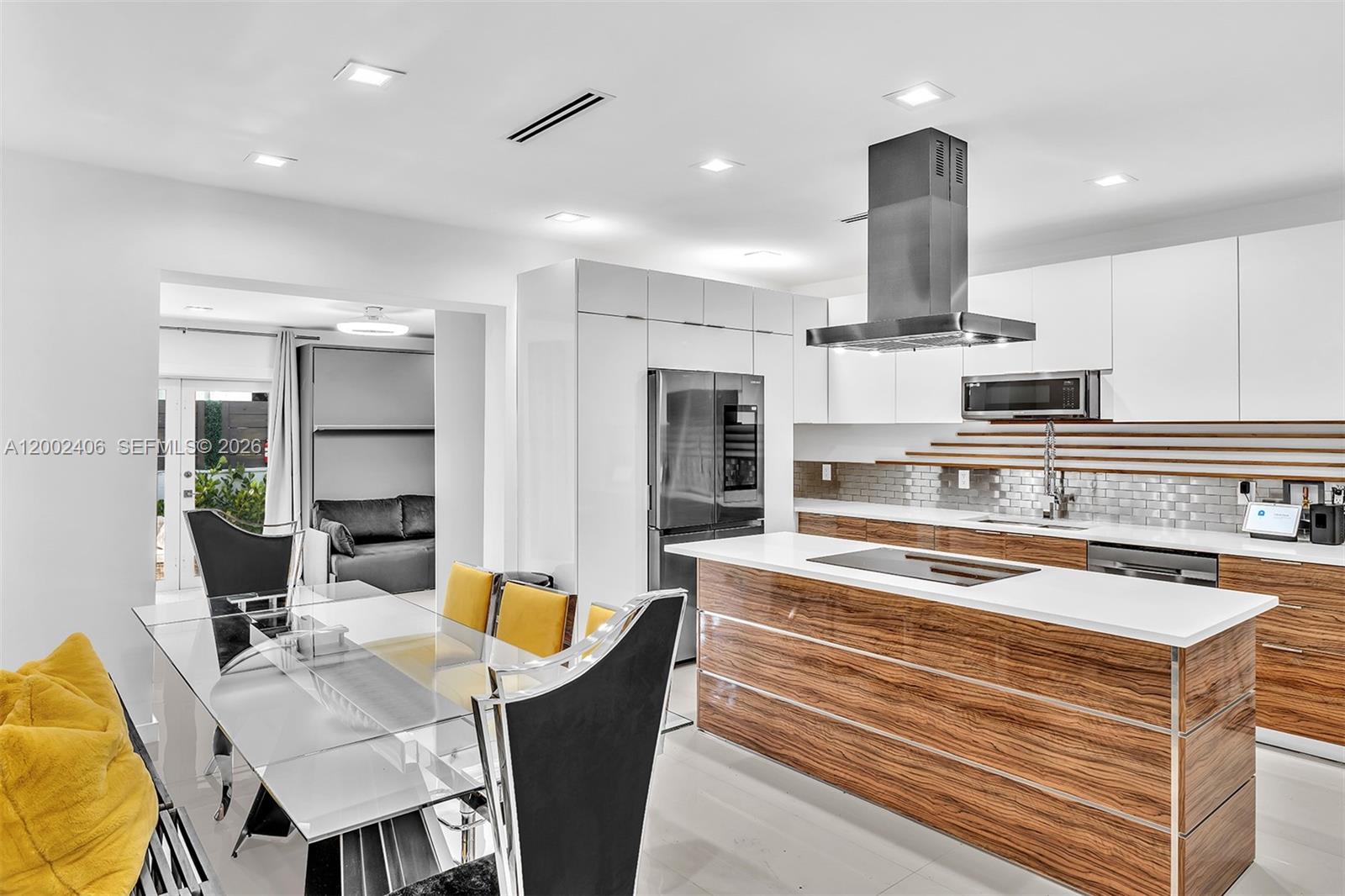 1002 10th Street, Unit 1002 Miami Beach, FL 33139 - Photo 27 of 71 a kitchen with stainless steel appliances kitchen island granite countertop a sink and white cabinets