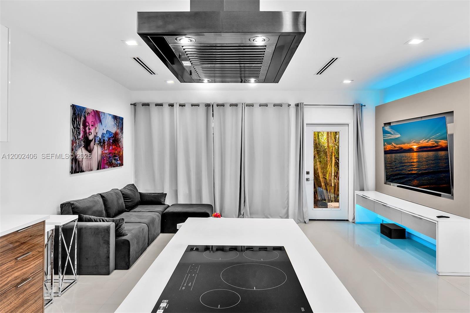 1002 10th Street, Unit 1002 Miami Beach, FL 33139 - Photo 30 of 71 a living room with furniture and a flat screen tv