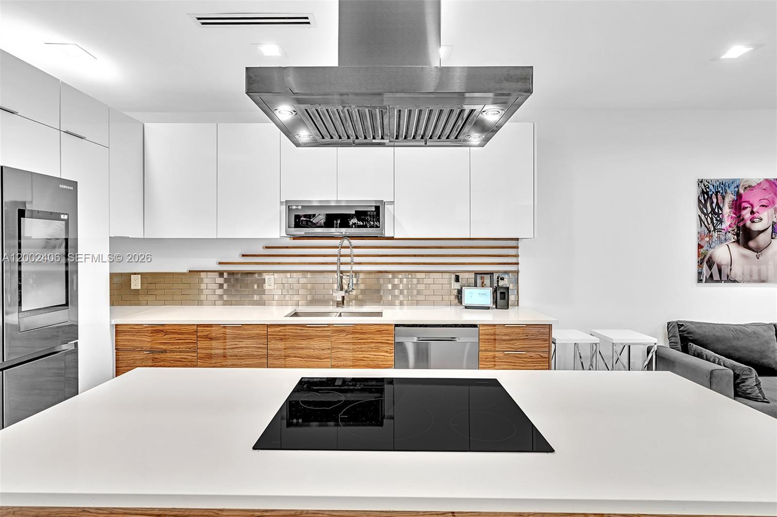 1002 10th Street, Unit 1002 Miami Beach, FL 33139 - Photo 33 of 71 a kitchen with stainless steel appliances a stove a sink and a refrigerator