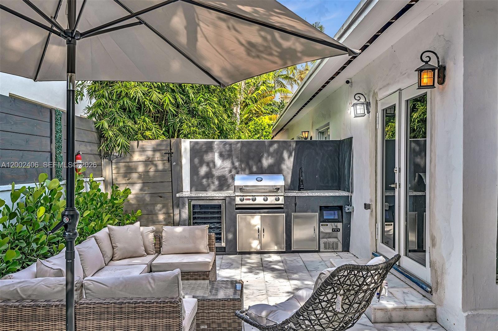 1002 10th Street, Unit 1002 Miami Beach, FL 33139 - Photo 41 of 71 a view of a patio with a table and chairs under an umbrella