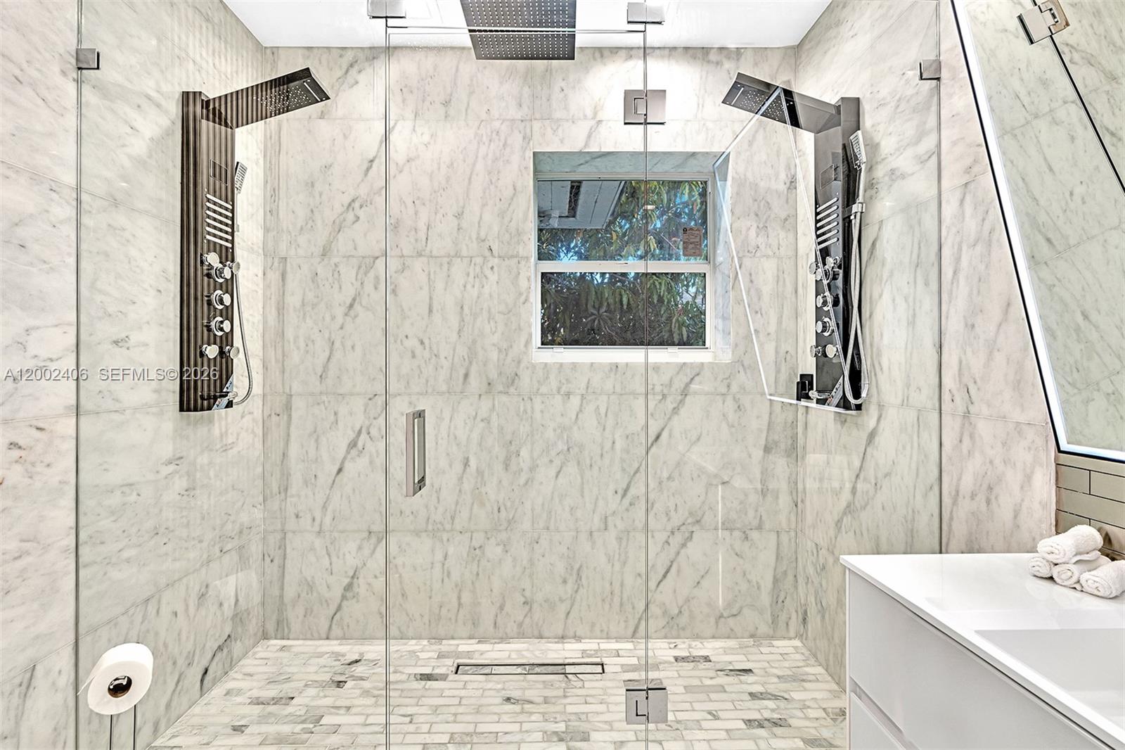 1002 10th Street, Unit 1002 Miami Beach, FL 33139 - Photo 50 of 71 a bathroom with a shower and a sink