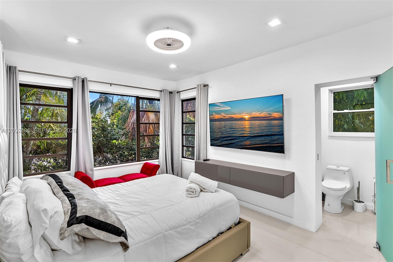 1002 10th Street, Unit 1002 Miami Beach, FL 33139 - Photo 54 of 71 a bedroom with a bed and a flat screen tv