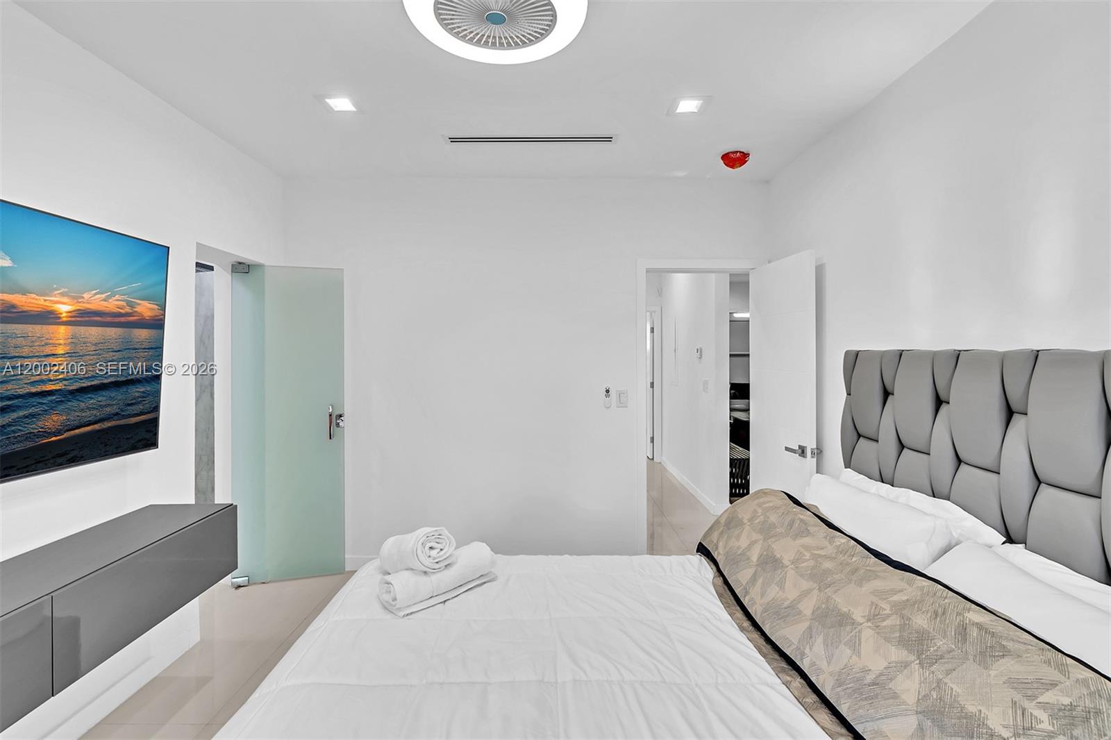 1002 10th Street, Unit 1002 Miami Beach, FL 33139 - Photo 55 of 71 a bedroom with a bed and a flat screen tv