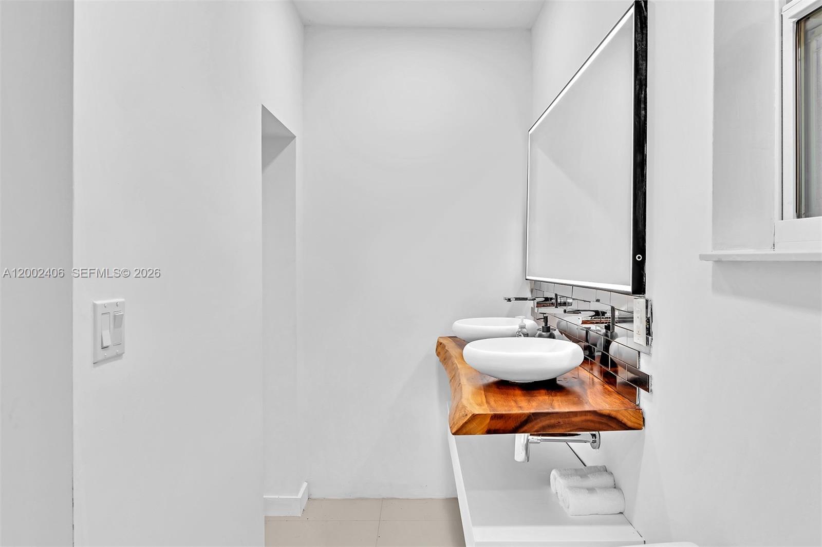 1002 10th Street, Unit 1002 Miami Beach, FL 33139 - Photo 57 of 71 a bathroom with a sink and a mirror