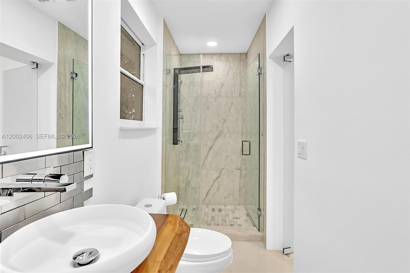 1002 10th Street, Unit 1002 Miami Beach, FL 33139 - Photo 58 of 71 a bathroom with a sink toilet and shower