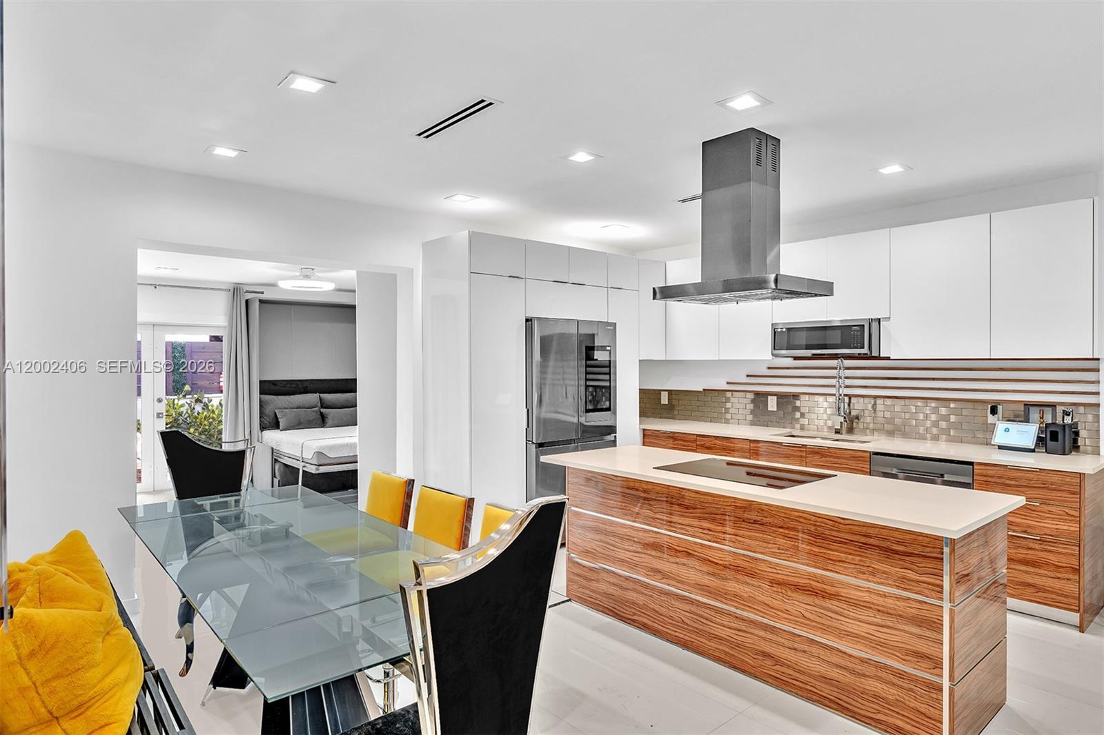 1002 10th Street, Unit 1002 Miami Beach, FL 33139 - Photo 6 of 71 a kitchen with stainless steel appliances kitchen island granite countertop a sink and cabinets