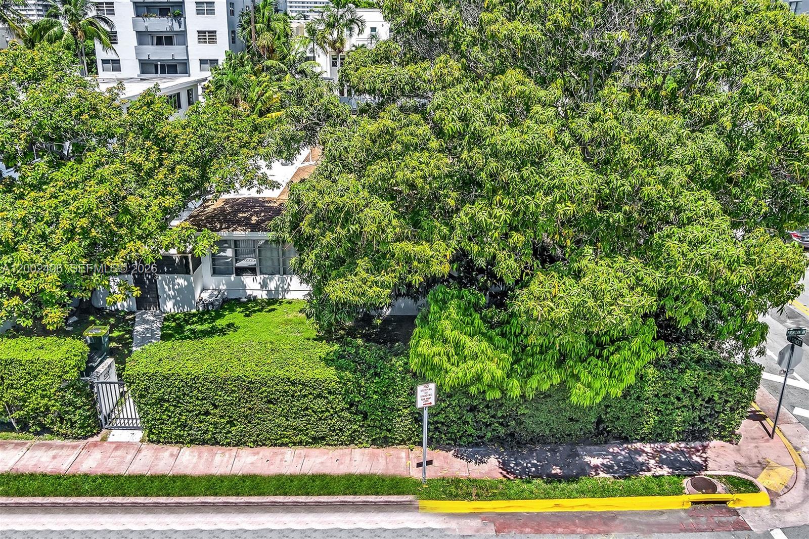 1002 10th Street, Unit 1002 Miami Beach, FL 33139 - Photo 70 of 71 a view of a swimming pool and trees in the background