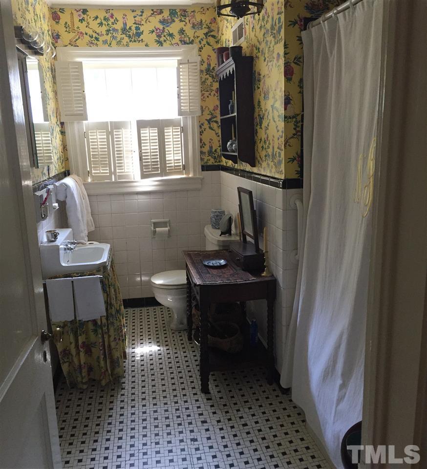 1418 Duplin Road Raleigh, NC 27607 - Photo 9 of 16 a bathroom with a sink a toilet and a window