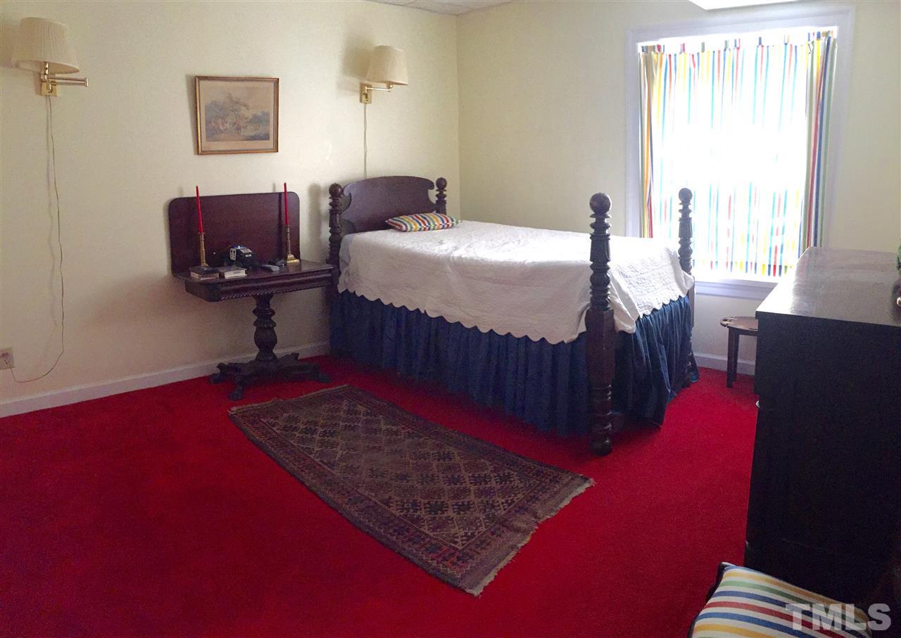 1418 Duplin Road Raleigh, NC 27607 - Photo 10 of 16 a bedroom with a bed rug and a window
