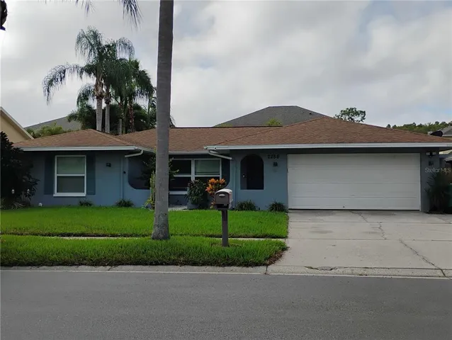 a view of a house with a backyard and porch