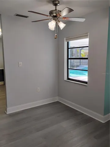 a view of a kitchen with a refrigerator wooden cabinets and wooden floor