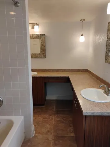 a patio with a table and chairs and potted plants