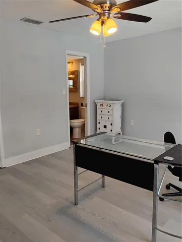 a view of a house with a small yard and wooden fence