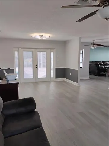 a living room with furniture and a lamp