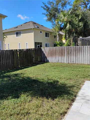 a palm plant sitting in front of a house