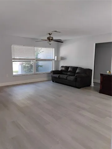 a living room with furniture window and wooden floor