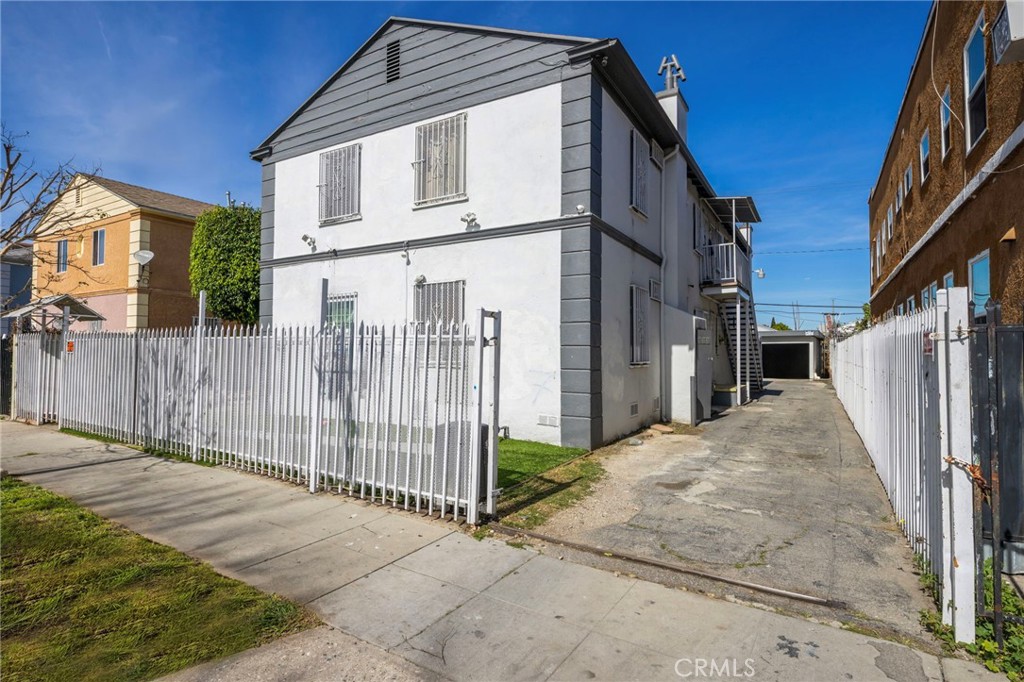 313 West Magnolia Street Compton, CA 90220 - Photo 2 of 11 a white house that has tree in front of it