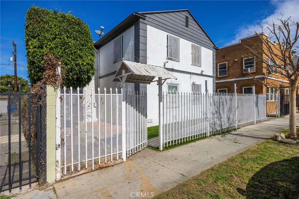 313 West Magnolia Street Compton, CA 90220 - Photo 2 of 11 a front view of a house with a yard
