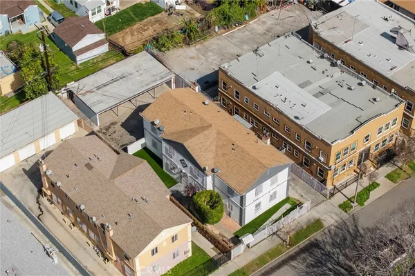 an aerial view of a house with a backyard