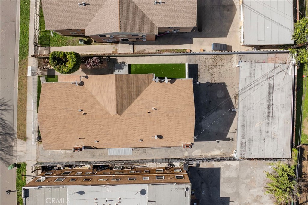 313 West Magnolia Street Compton, CA 90220 - Photo 6 of 11 a kitchen with stainless steel appliances kitchen island granite countertop a stove a sink and white cabinets
