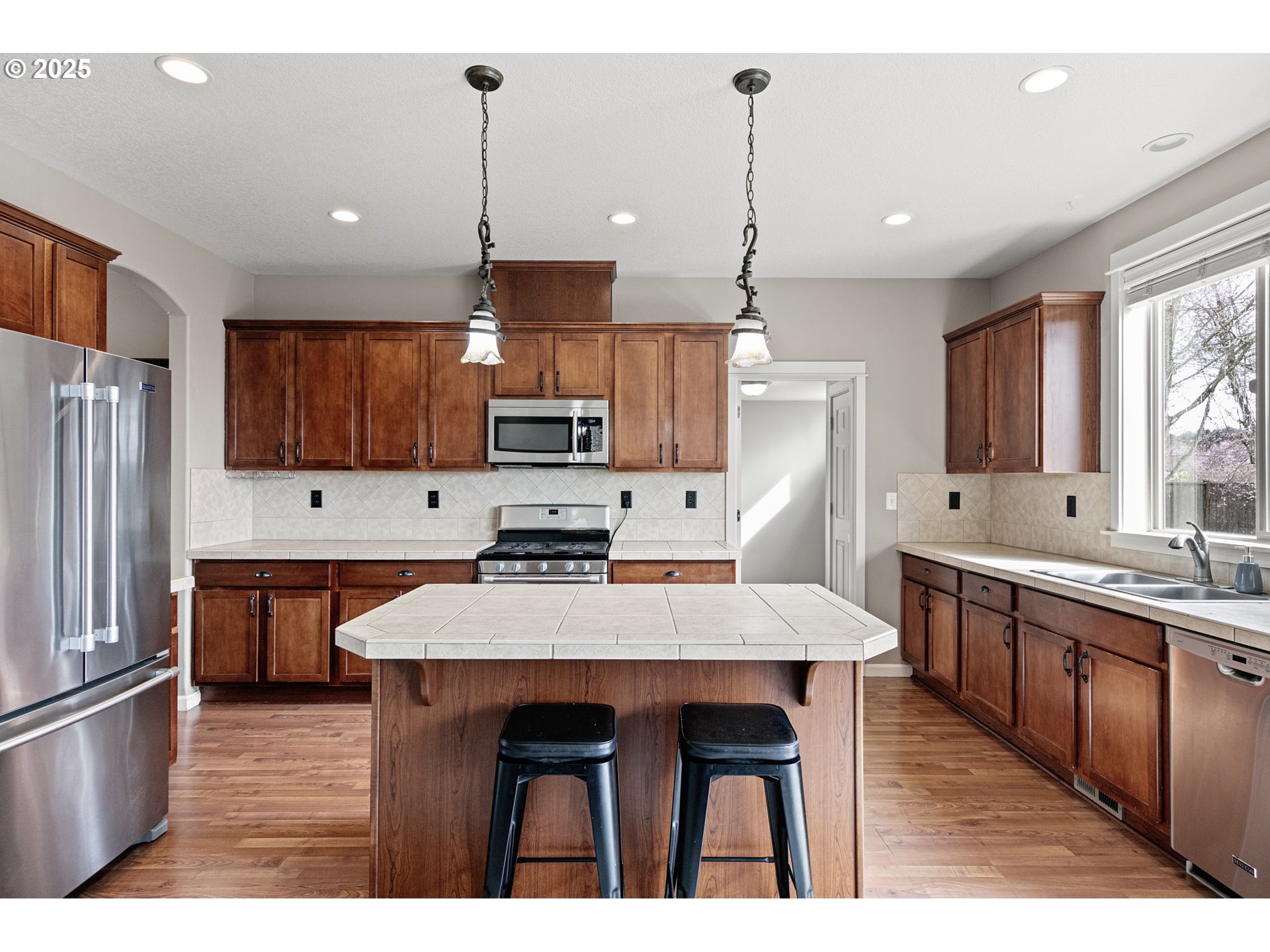 5462 Pranz Place Eugene, OR 97402 - Photo 13 of 43 a kitchen with stainless steel appliances a sink stove and refrigerator