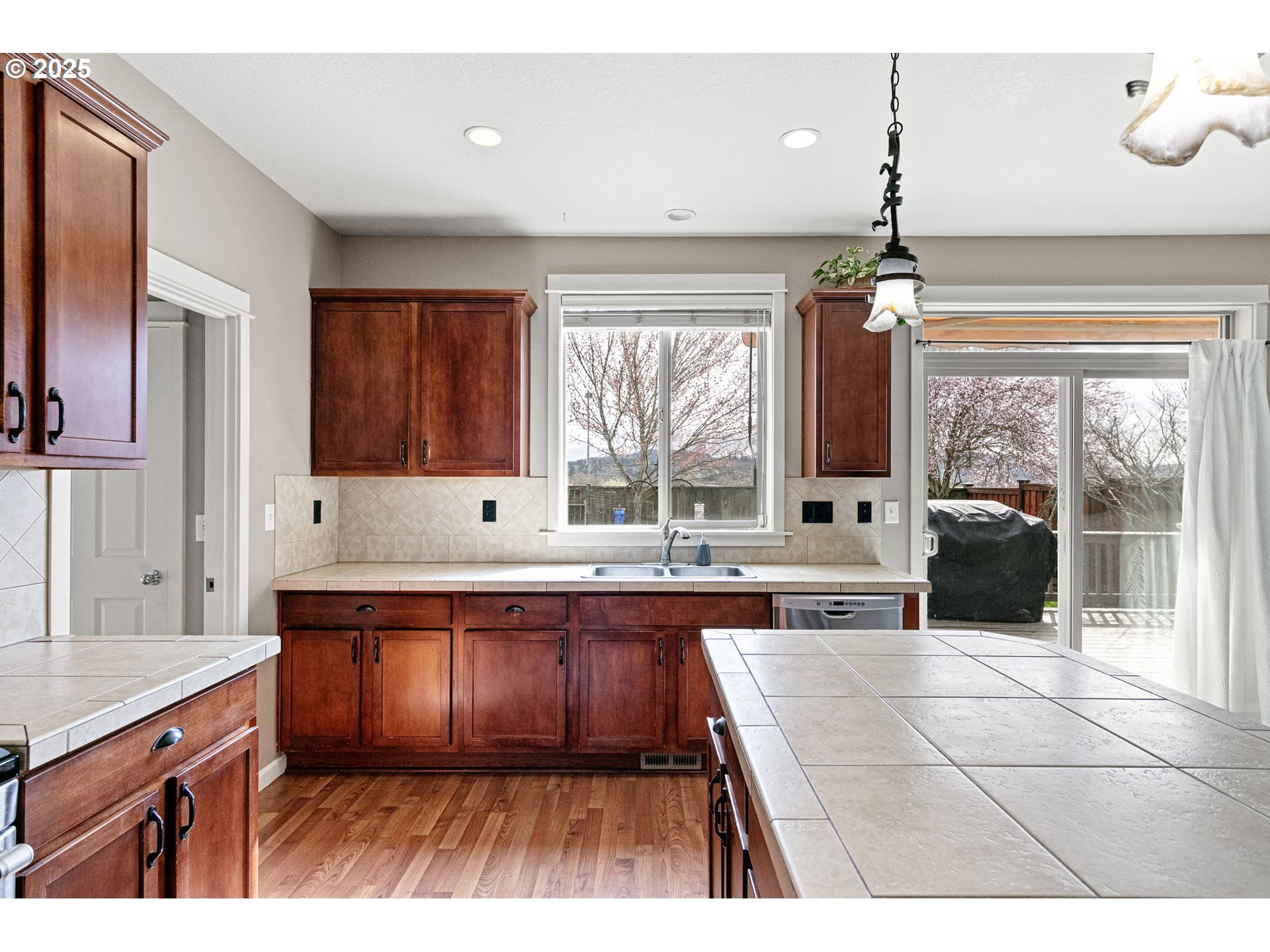 5462 Pranz Place Eugene, OR 97402 - Photo 15 of 43 a large kitchen with kitchen island a sink stainless steel appliances and cabinets