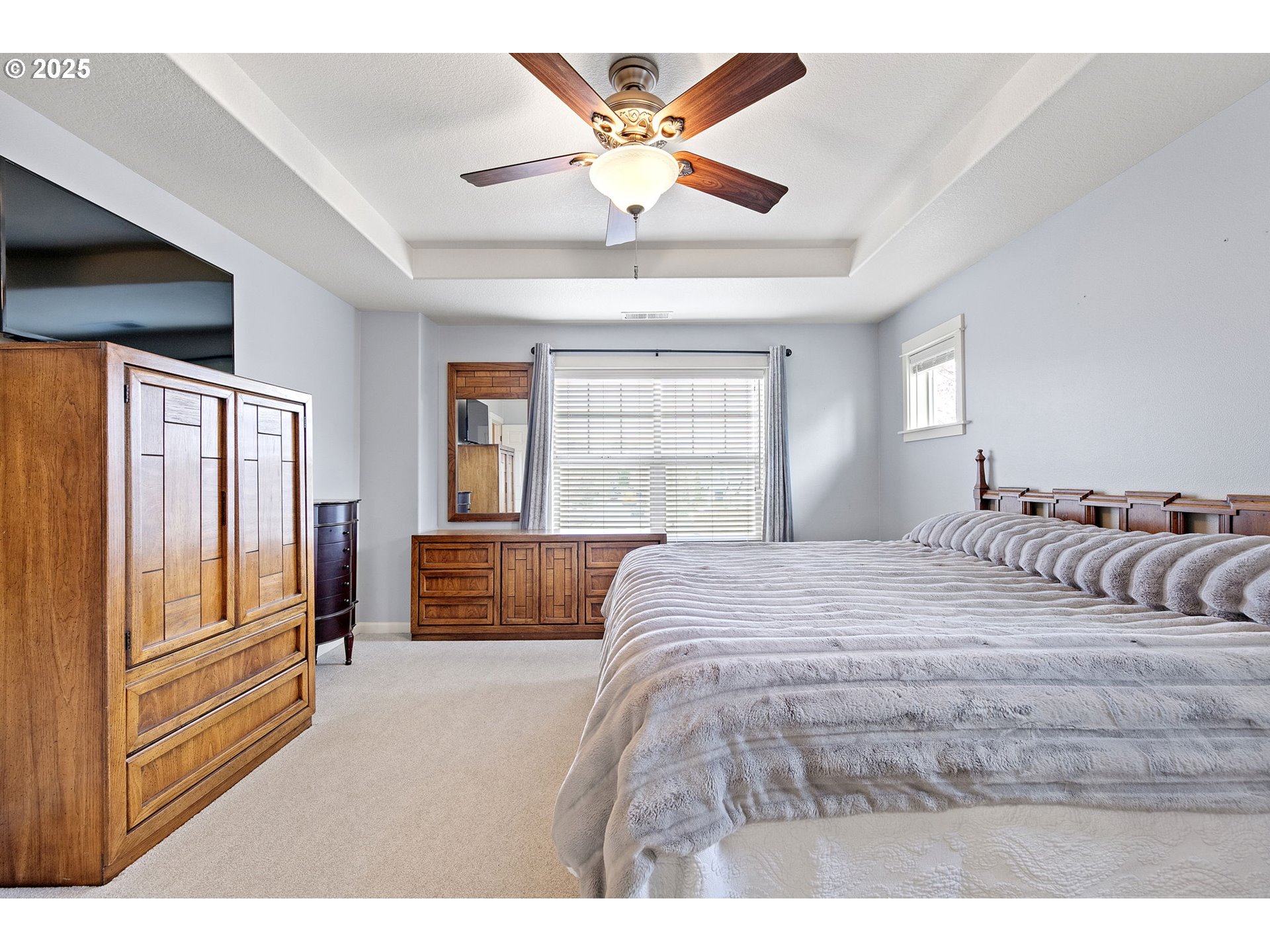 5462 Pranz Place Eugene, OR 97402 - Photo 24 of 43 a bedroom with a large bed and a chandelier