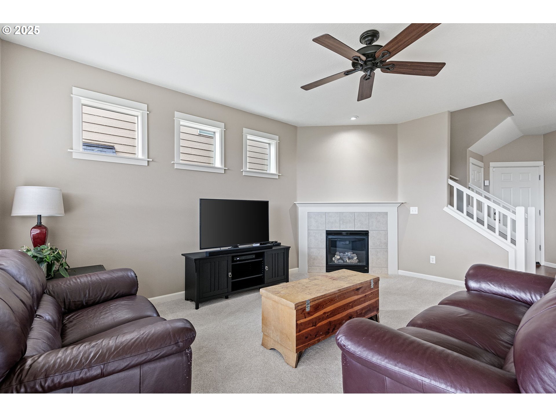 5462 Pranz Place Eugene, OR 97402 - Photo 3 of 43 a living room with furniture a fireplace and a flat screen tv