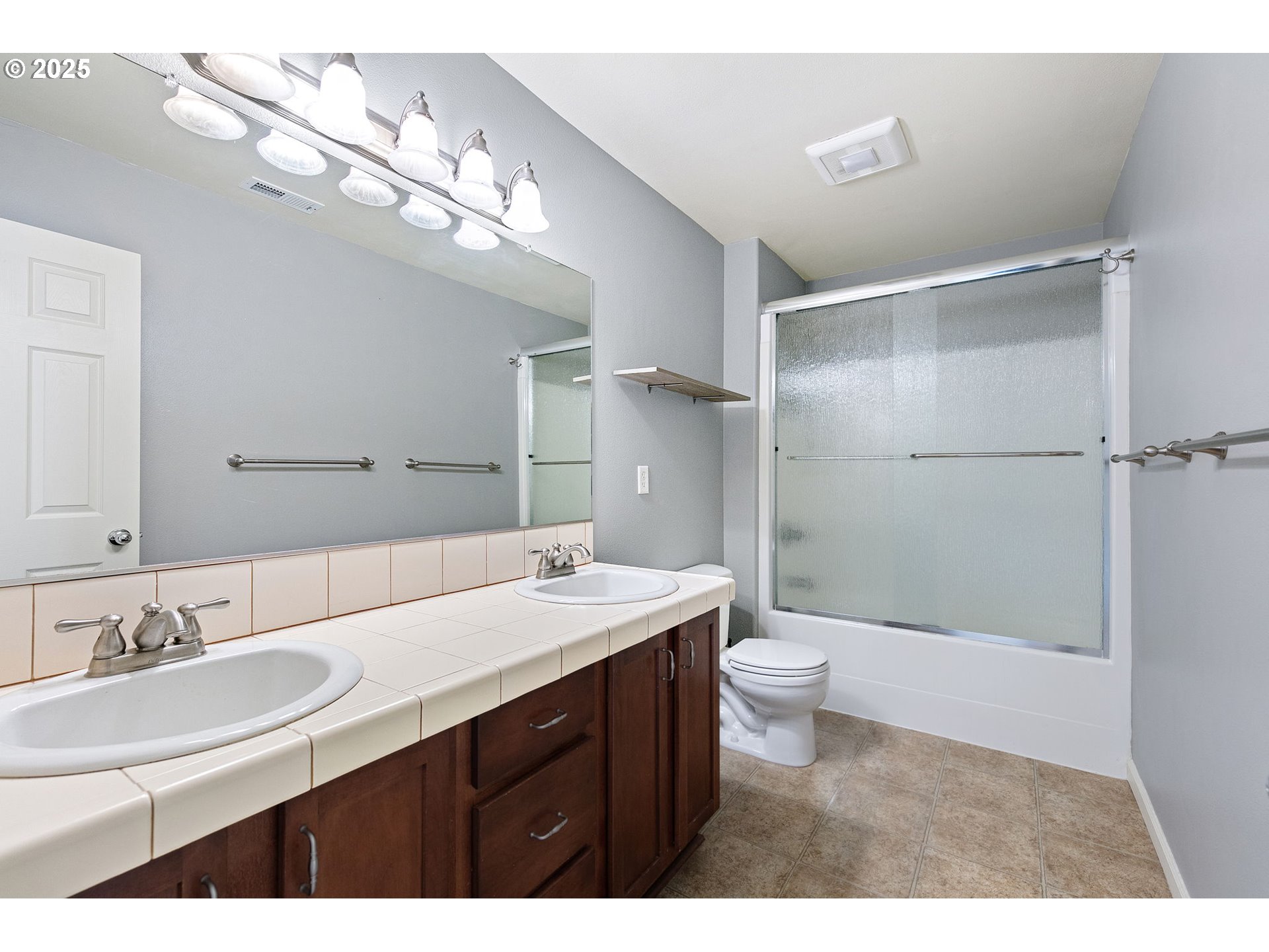 5462 Pranz Place Eugene, OR 97402 - Photo 31 of 43 a bathroom with a double vanity sink a toilet and a mirror