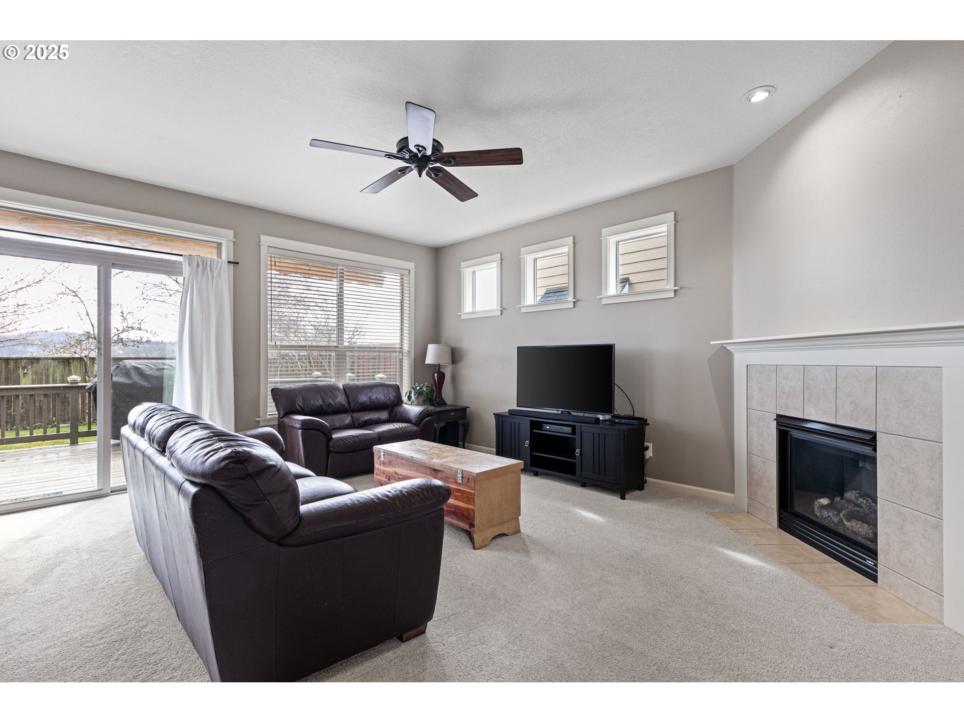 5462 Pranz Place Eugene, OR 97402 - Photo 4 of 43 a living room with furniture a fireplace and a flat screen tv