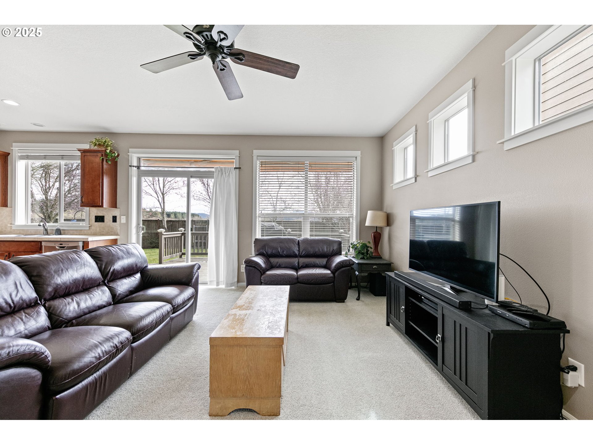 5462 Pranz Place Eugene, OR 97402 - Photo 7 of 43 a living room with furniture a flat screen tv and a window