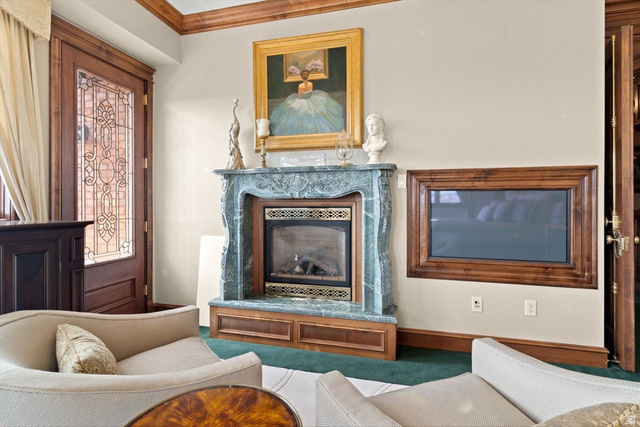 5615 East Eight Mile Gap Road Kanab, UT 84741 - Photo 16 of 81 Living area featuring a fireplace, ornamental molding, and carpet floors