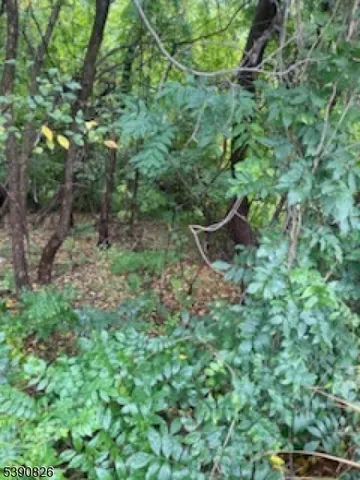 a view of house with outdoor space and parking