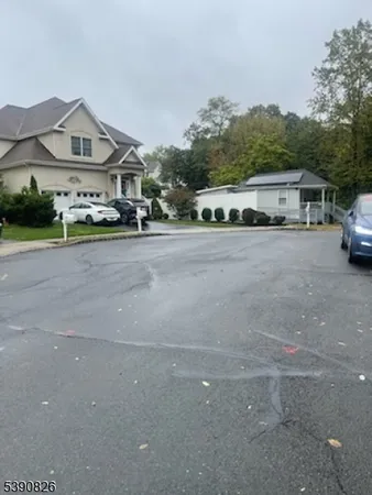 a front view of a house with a yard and car parked