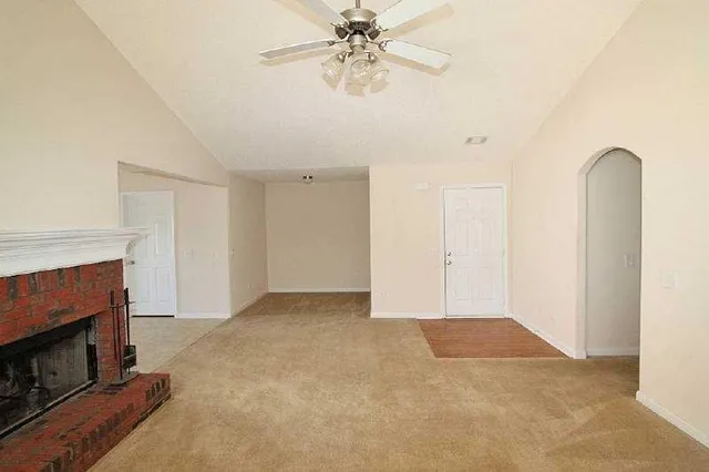 a view of an empty room with a fireplace