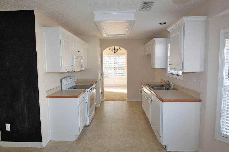 210 Joe Graham Road Hull, GA 30646 - Photo 9 of 21 a kitchen with a sink stove top oven and cabinets