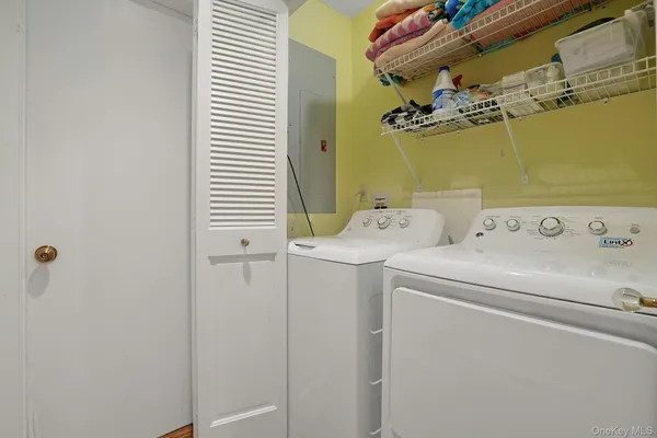 a bedroom with a bed and painting on the wall