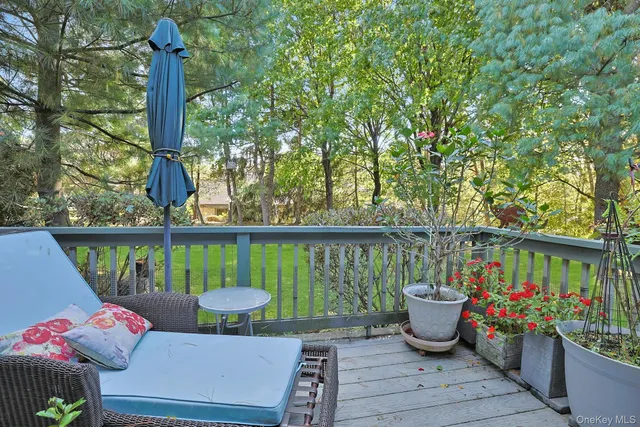 a view of a balcony with chairs and wooden floor