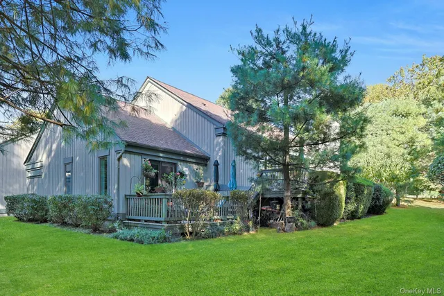 a front view of house with a garden