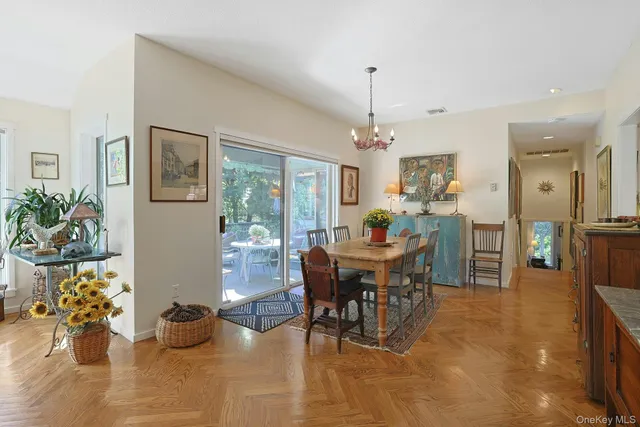 a view of a dining room with furniture and a chandelier