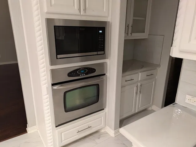 a kitchen with a stove and a microwave