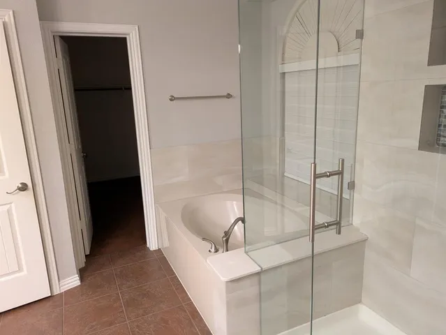 a bathroom with a shower and a sink
