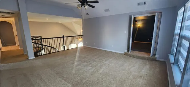 a view of an empty room with windows