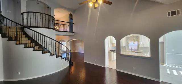a view of entryway and hall with wooden floor