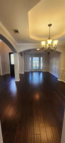 a view of a room with wooden floor