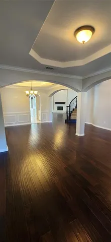 a view of a room with wooden floor