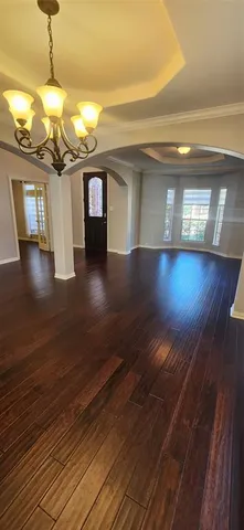 a view of a room with wooden floor