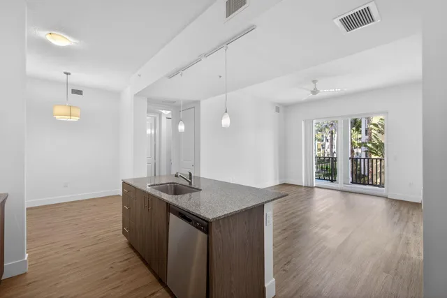 a kitchen with a sink cabinets and wooden floor