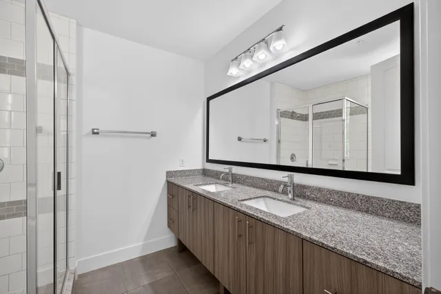 a bathroom with a granite countertop sink mirror and vanity